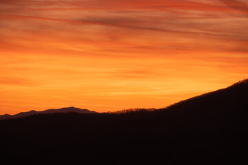 Streaking Orange Clouds Over Ridge