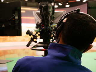 professional cameraman using a professional camcorder at TV station.