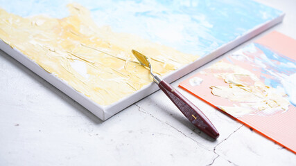 Ocean acrylic painting with palette knife on canvas with blue and turquoise. Golden sand on beach with trowel texture technic. Water splash art hand paint.  Summer and seascape feeling and tone.