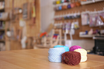 Crochet thread in group as many colors in studio of handicraft school as background. Needles craft...