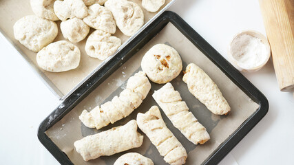 Whole wheat bread from homemade whole grain dough made by woman with red apron. Healthy pastry with many grains.