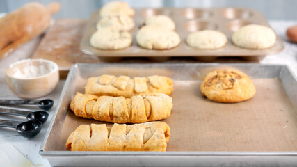 Whole wheat bread from homemade whole grain dough made by woman with red apron. Healthy pastry with many grains.