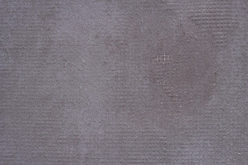 Plastered grey wall close up. Textured background.