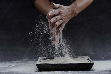 hand clap for making dough for bread or pastry. with black background