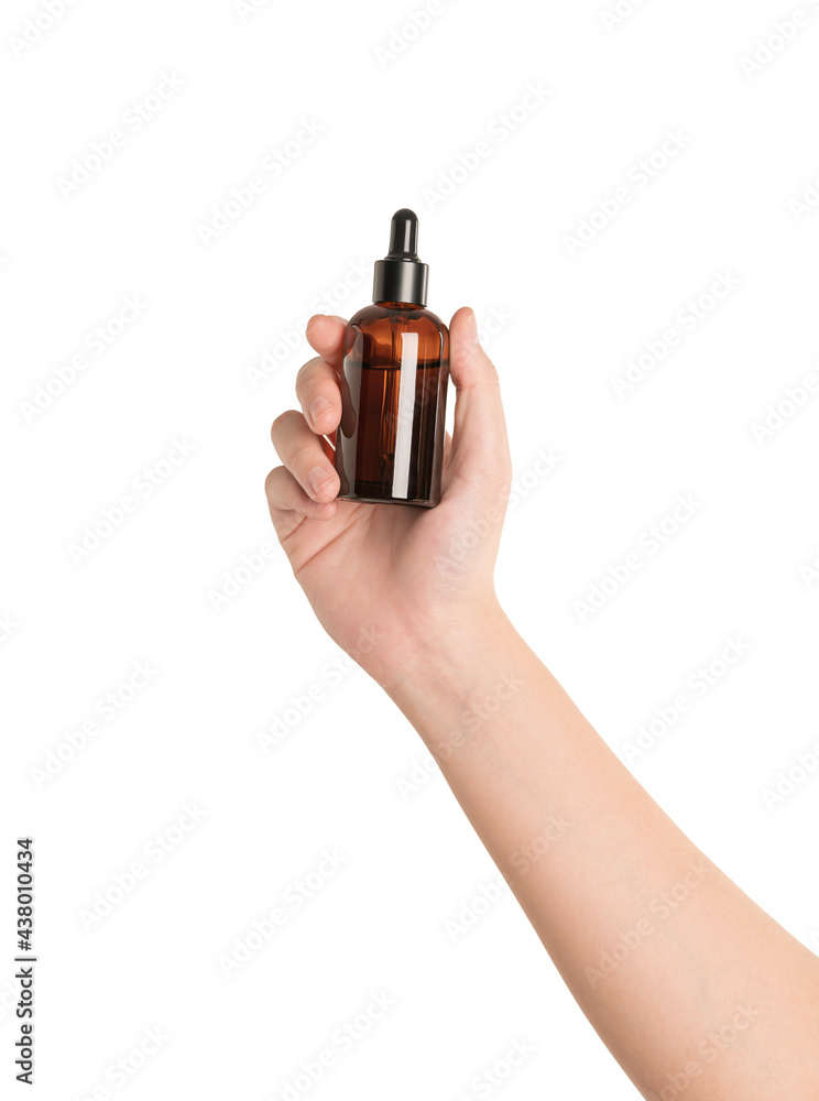 Wall mural woman hand holding a bottle serum isolated on white background.