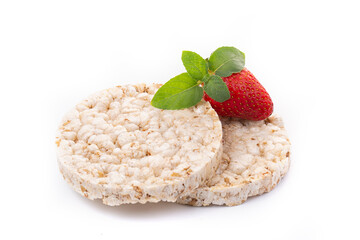 Airy oatmeal crispbreads in the form of breakfast slices decorated with mint leaf with strawberries. Dietary healthy food.