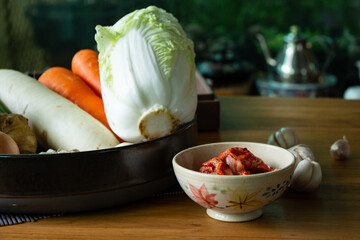 Kimchi,Korean cuisine famous  traditional side dish and fermented vegetables, cabbage and radish, spicy and smelly seasonings including apple, mushroom. Preparation of making kimchi