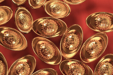 Golden chinese traditional money on red color background. Representing rich, wellness, properity, lucky, happiness for Chinese New Year celebration