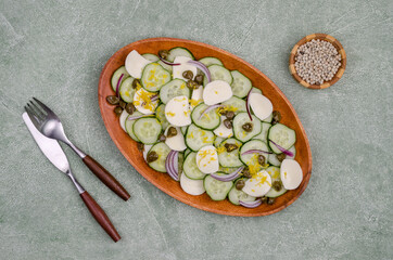 Salad of cucumbers, cheese, capers and lemon zest