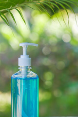 Fototapeta na wymiar Bottle of hand sanitizer gel with natural background