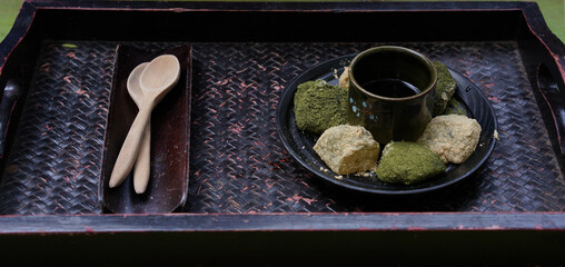 Warabi mochi, japanese soft glutinous rice with sweet sticky sauce for dipping wth cake. Green tea...