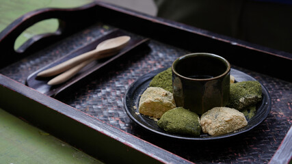 Warabi mochi, japanese soft glutinous rice with sweet sticky sauce for dipping wth cake. Green tea...