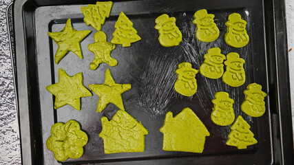 Green ginger bread cookies homemade cooking for Christmas traditional dessert. Kids and family love to prepare green tea cookies. Celebration cookies for Christmas.