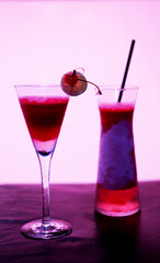 Pink cocktail at bar. Strawberry mixed with lemon and liquor at night club on bar. Lady favorite drink.