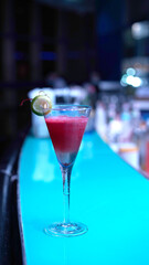 Pink cocktail at bar. Strawberry mixed with lemon and liquor at night club on bar. Lady favorite drink.