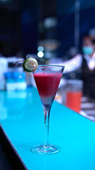 Pink cocktail at bar. Strawberry mixed with lemon and liquor at night club on bar. Lady favorite drink.