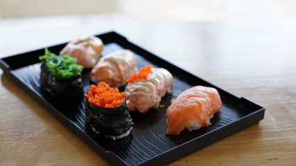 Sushi on plate. Variety Japanese rice in roll with many kinds of topping. Healthy menu.