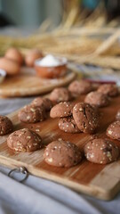 Oatmeal and banana chocolate cookies while preparation from dough to baking. Dessert recipe of pastry. Sweet homemade bake