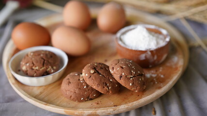 Oatmeal and banana chocolate cookies while preparation from dough to baking. Dessert recipe of pastry. Sweet homemade bake