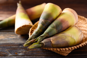 Fresh bamboo shoot in a basket on wooden background, Edible vegetable in Asian cuisine