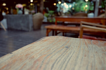 wood table on blur of cafe, coffee shop, bar, resturant, background - can used for display or montage your products