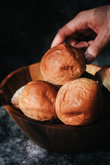 Homemade sourdough and bread bun. Freshly baked bread. Organic whole-wheat loaves. Simple breakfast on grey concrete background. 