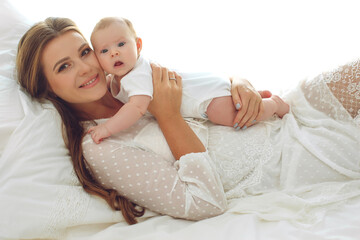 Portrait of a beautiful mother, with her nursing baby. High quality photo. - 438033492