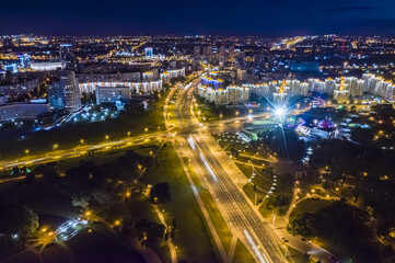 night cityscape with illuminated buildings and streets in Minsk city, Belarus. aerial view.