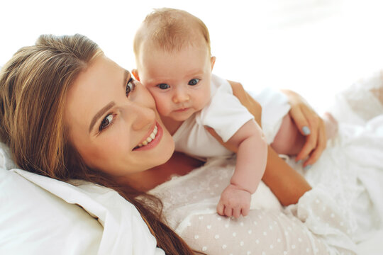Portrait of a beautiful mother, with her nursing baby. High quality photo.