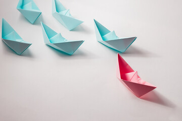 The organizational leadership concept uses a pink paper boat that represents leadership in a team or unit.
