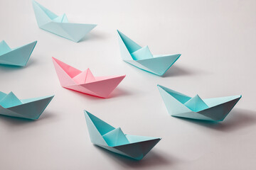 The organizational leadership concept uses a pink paper boat that represents leadership in a team or unit.
