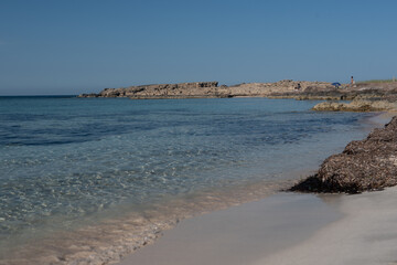 People enjoying the beautiful transparent water beach on the Island of Formentera in Spain summer 2021.