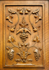 Wine grapes bas relief of polished wood