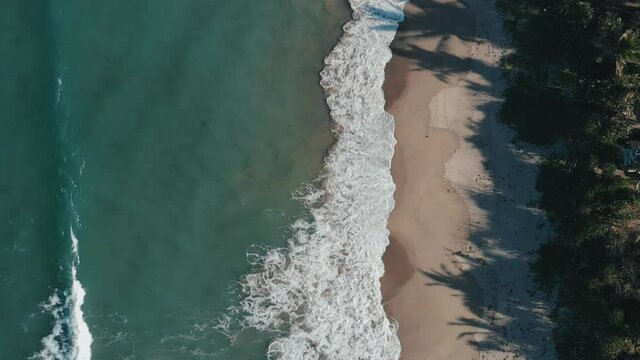 Beautiful landscape of waves breaking on coast. Aerial, birds eye rising