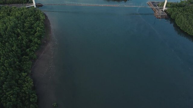 Bridge over the ocean surrounded by mangroves Manito, Albay, Philippines. Cinematic aerial revealing shot