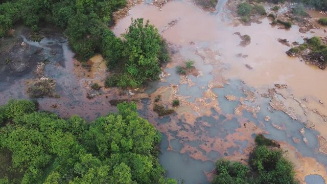 Steam rising over the boiling lake, Nag Aso, Manito Albay, Philippines. Cinematic aerial tilting up shot