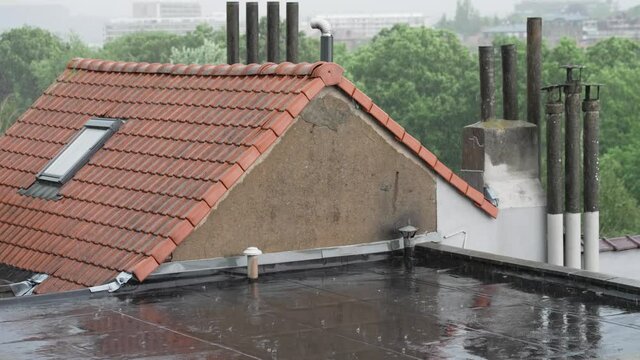 Heavy Rain with lightning on the rooftops in the suburbs - static slow motion shot