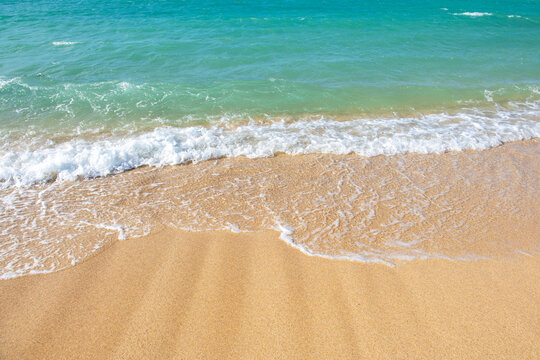 Blue ocean wave on sandy beach. Beach in sunset summer time. Beach landscape. Tropical seascape, calmness, tranquil relaxing sunlight.