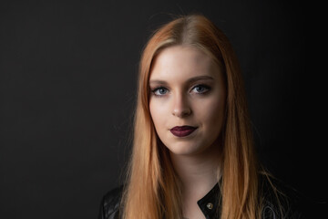 Portrait of beautiful young woman on the black background Horizontally. 