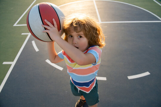 Little child boy playing basketball with basket ball. Basketball school.