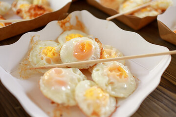 fried quail eggs on paper plate