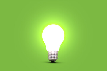 Glowing light bulb isolated on green background. Idea and innovation concept.
