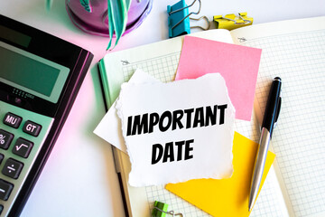 Closeup of a personal agenda setting an important date writing with pen. The words Important date...