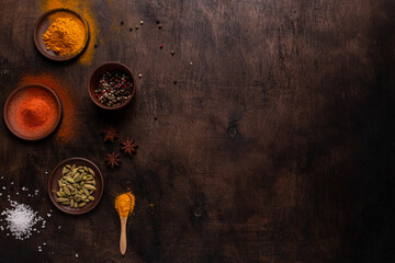 Obraz na płótnie Canvas Different spices on a wooden background