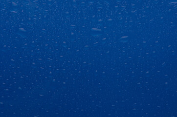 Blue ultramarine wet water drops texture. Bright rain background.