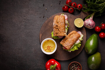 Sandwiches with vegetables for lunch on a black background