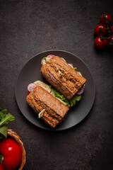 Sandwiches with vegetables for lunch on a black background