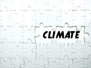 Fototapeta premium Selective focus.Text CLIMATE with jigsaw puzzle on white background.