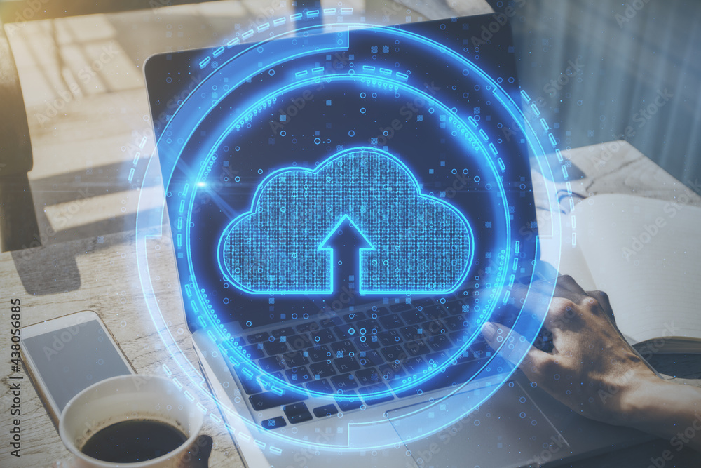 Poster Close up of hand at desktop using laptop and smartphone with glowing digital cloud on blurry background. Cloud computing and innovation concept. Double exposure.