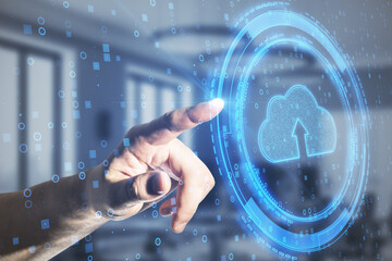 Hand pointing at glowing digital cloud on blurry background. Cloud computing concept. Double exposure.